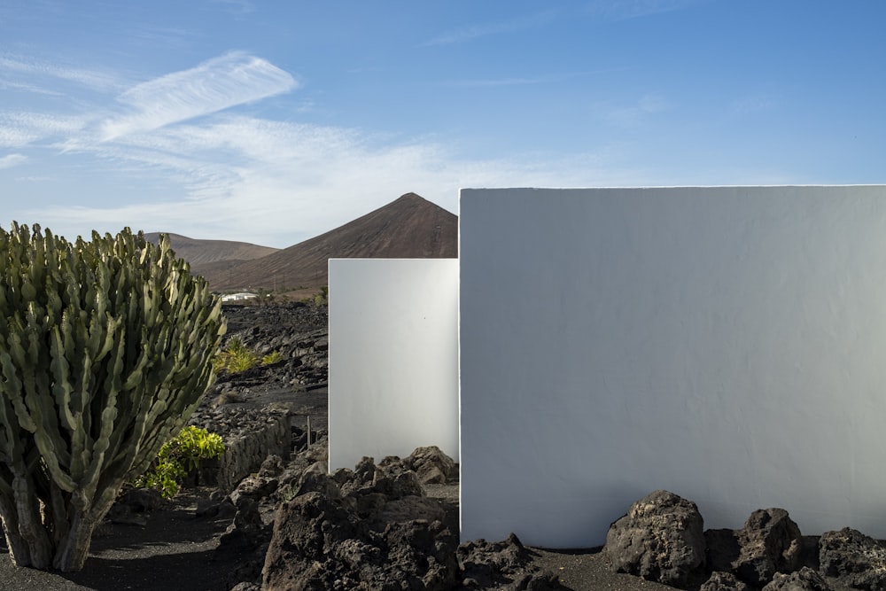 two white boxes sitting in the middle of a desert