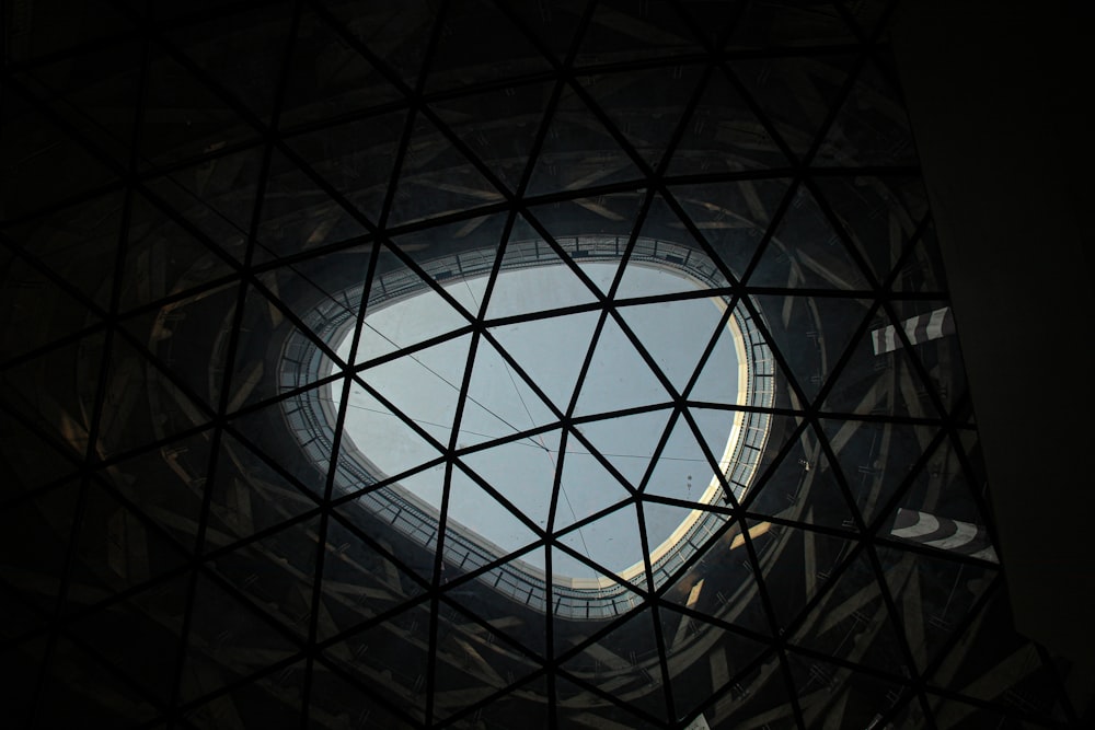 a view of a circular window through a wire structure