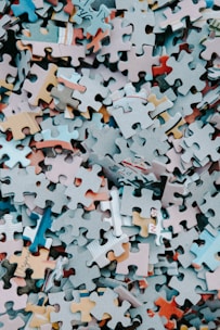 a pile of different colored puzzle pieces