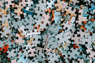 a pile of different colored puzzle pieces