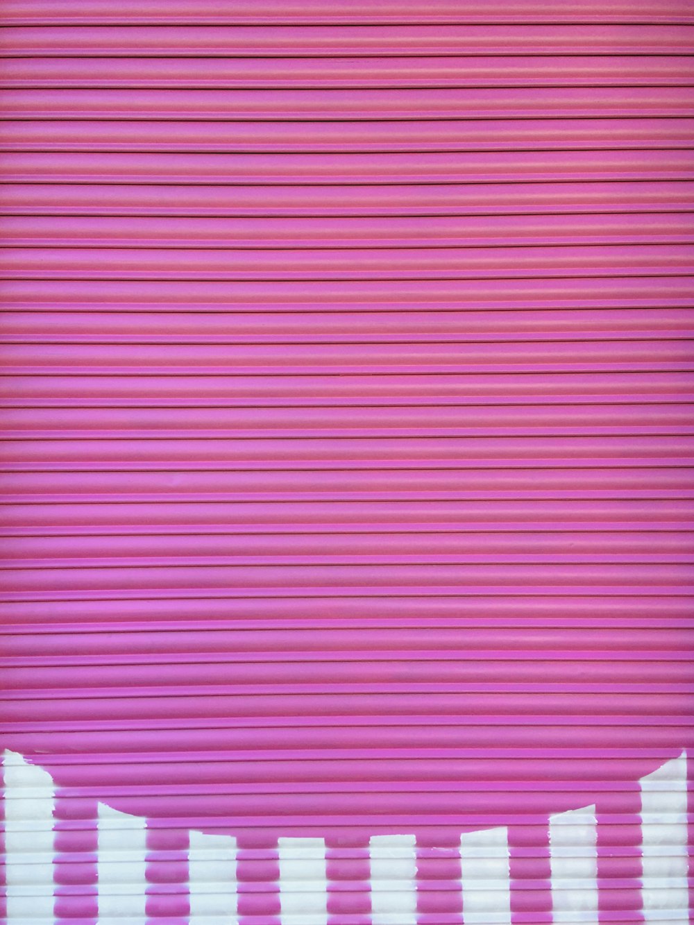 a close up of a pink roller door