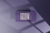 A minimalist card with rounded corners and the letters SRCBCM prominently displayed in large white font on a purple background. Below it, smaller text reads 'Single Rounded Corner Business Card'. Shadows from a window create geometric patterns on the surface.