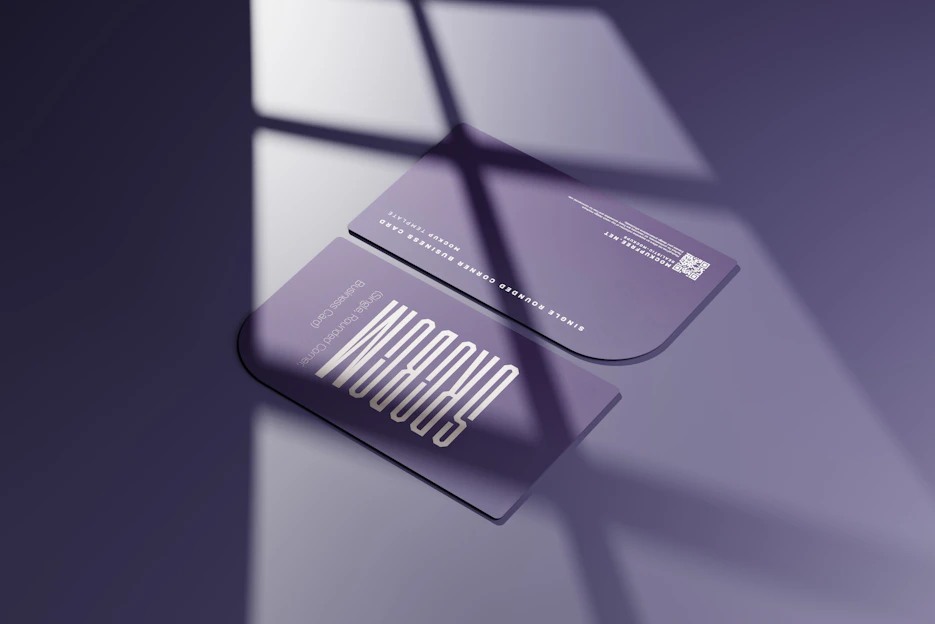 A sleek modern ID card displayed on a wooden desk with creative branding elements around it