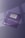 Two purple business cards featuring sleek typography and a single rounded corner are placed on a surface with soft shadows. The foreground card prominently displays the brand name in bold letters, while the background card includes contact details and a QR code in white text.
