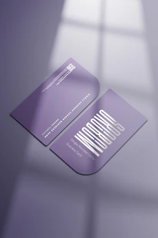 Close-up of a sleek QR business card with a vibrant design on a wooden desk