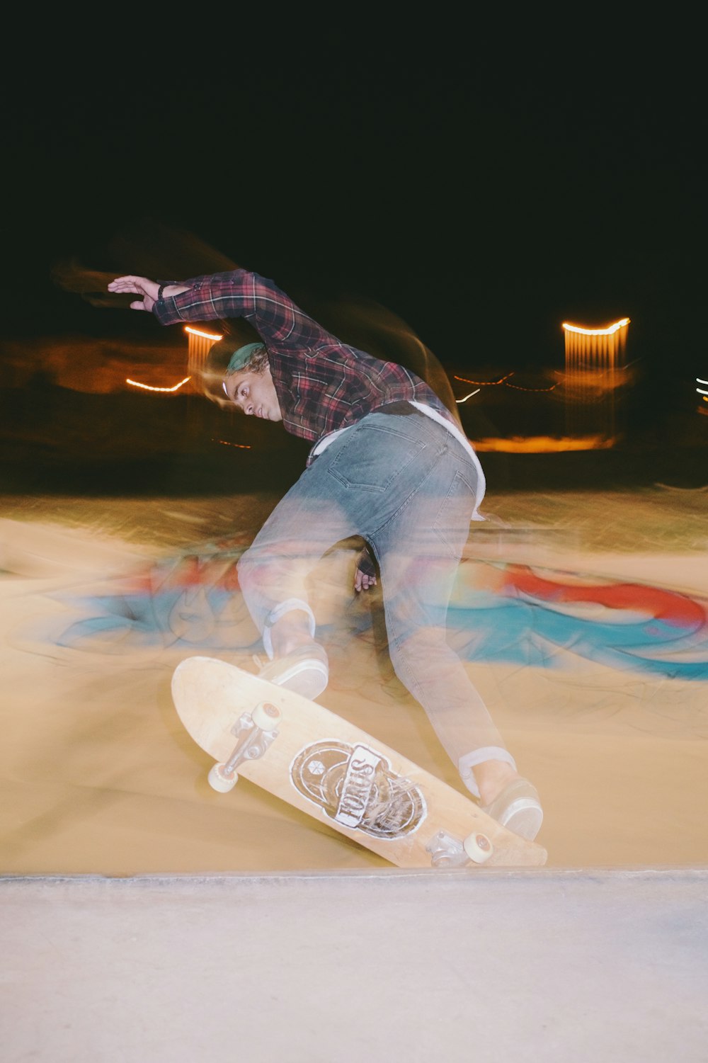 a man riding a skateboard on top of a cement ramp