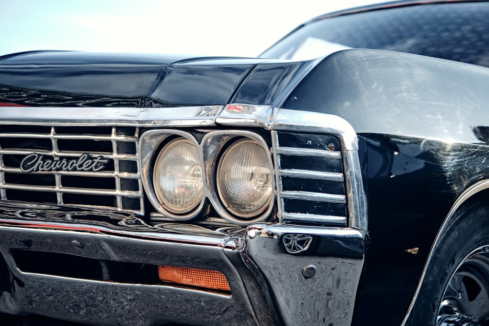 a close up of the front of a classic car