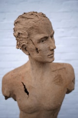 A detailed sculpture made from clay displayed in a studio.