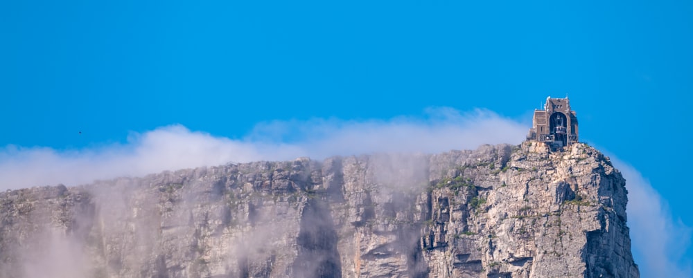 a tall mountain with a clock tower on top of it