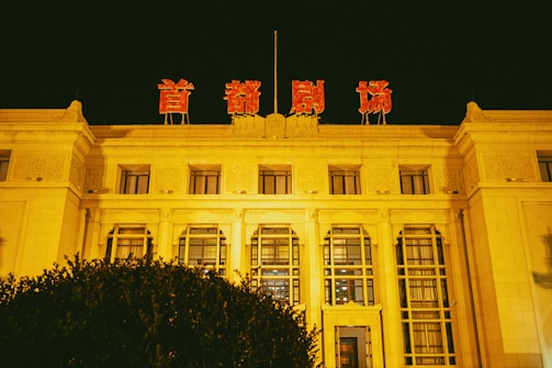 Nighttime exterior of a grand theatre lit up for a touring show.