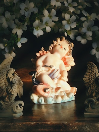A charming figurine holding a tiny flower, radiating gentle warmth.