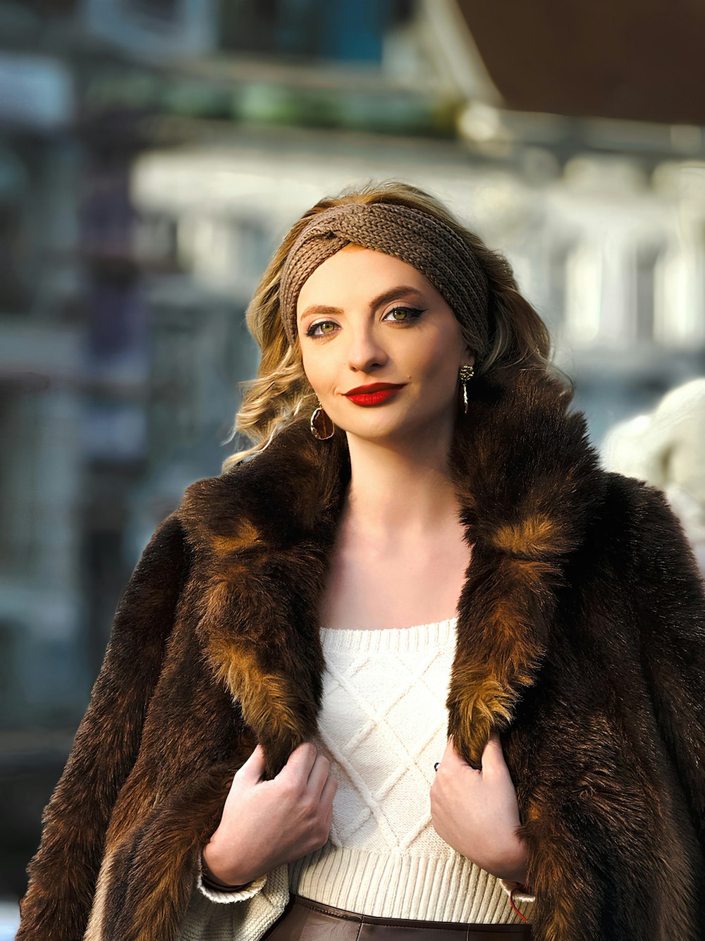 a woman in a fur coat is posing for a picture