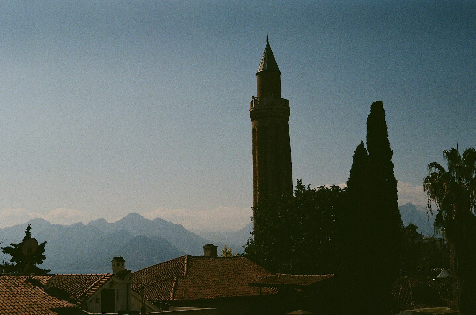 The fluted Yivli Minaret rising above the rooftops of Kaleiçi, Antalya's old town, with the Taurus Mountains behind