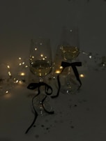 Elegant wine glasses filled with red and white wine at a festive gathering.