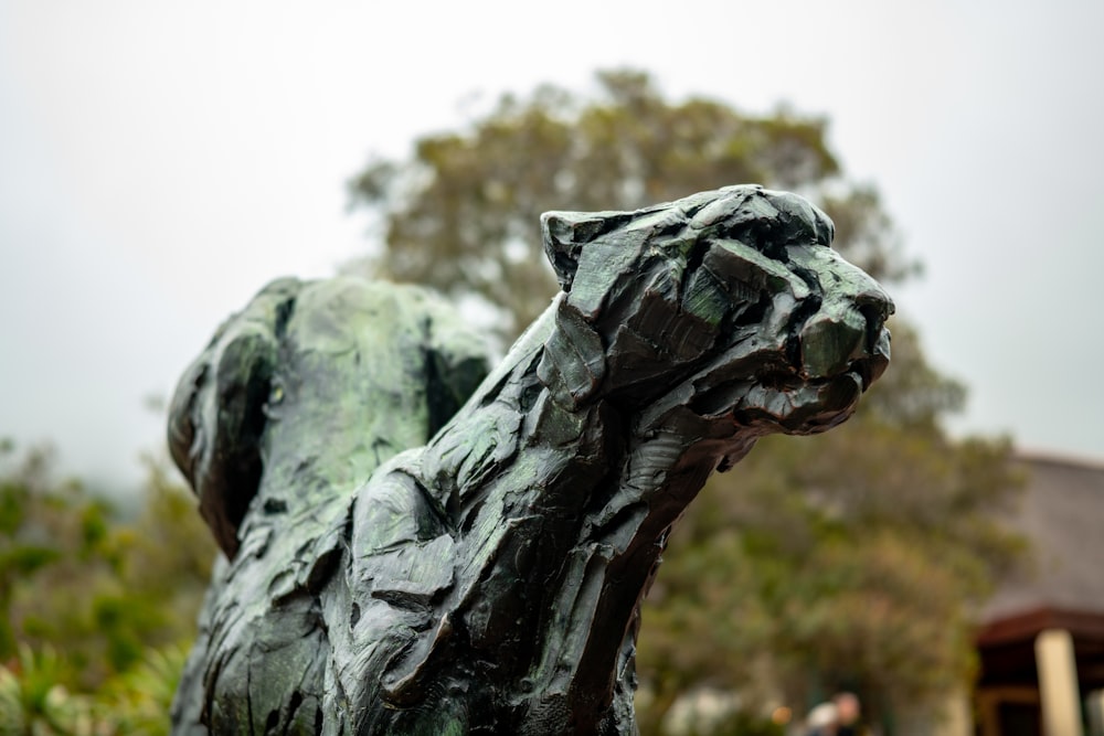 a statue of a cat in front of a building