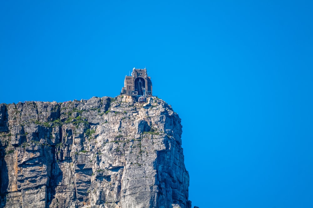 a very tall mountain with a small tower on top of it