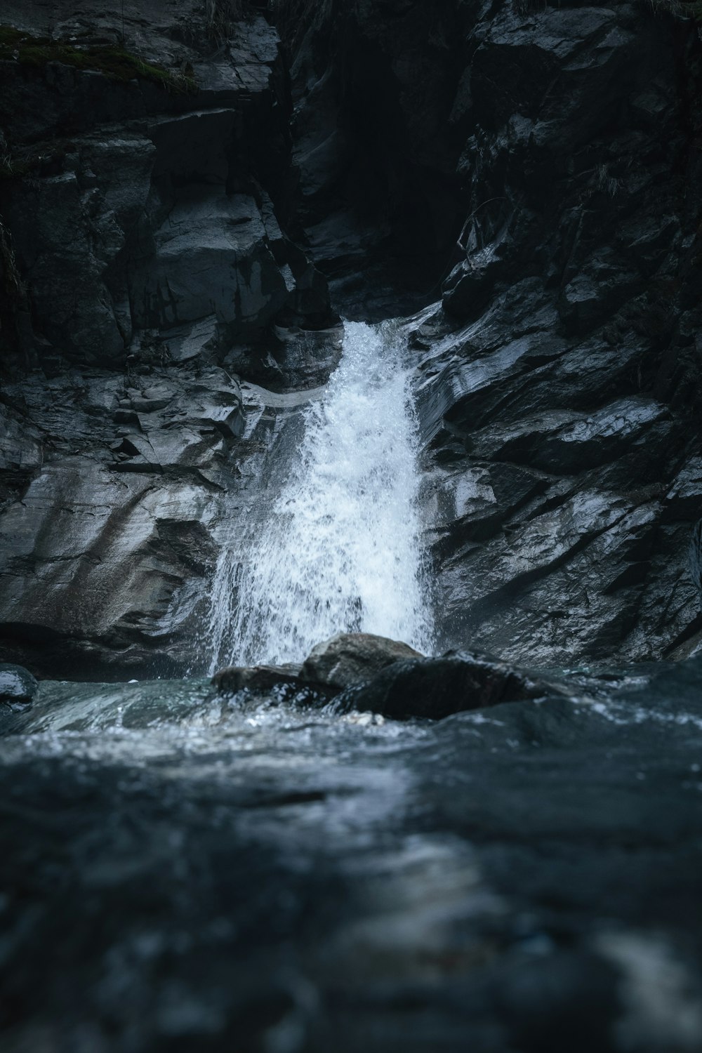 a small waterfall in the middle of a river