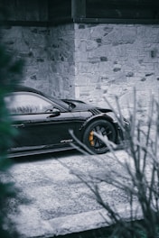 Red Porsche 911 GT3 parked on a sleek black gradient background, right side view.