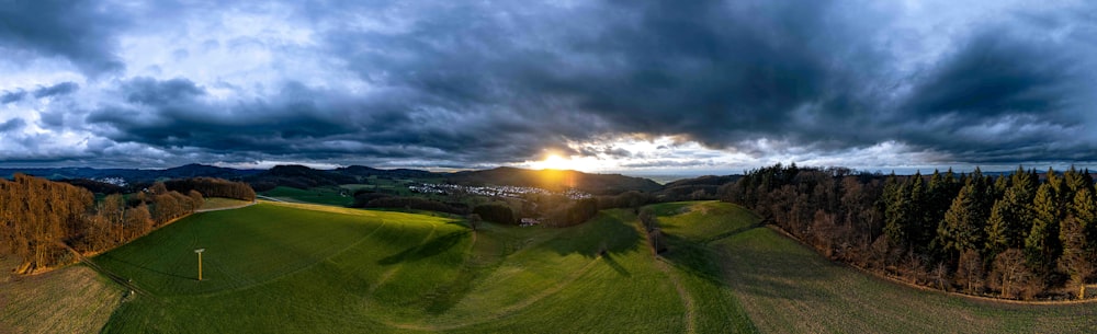 the sun is setting over a golf course