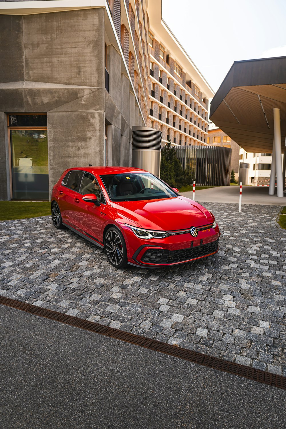 a red car parked in front of a building