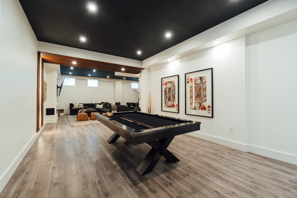 a room with a pool table and couches