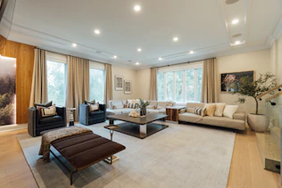 Luxurious living room with bespoke lounge design furniture in neutral tones.