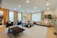 Elegant living room with soft beige tones and gold accents, showcasing modern luxury design.