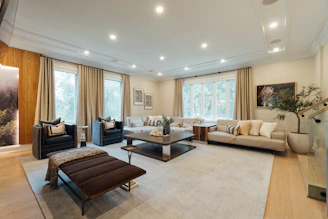 a living room filled with furniture and a large window