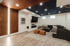 a living room with a couch a chair and a flat screen tv