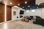 a living room with a couch a chair and a flat screen tv