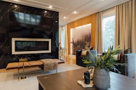 Spacious living room featuring a large screen TV and a welcoming fireplace with plush seating.