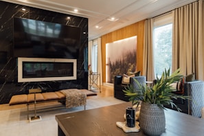 Modern dark-themed living room with custom electrical automation panels