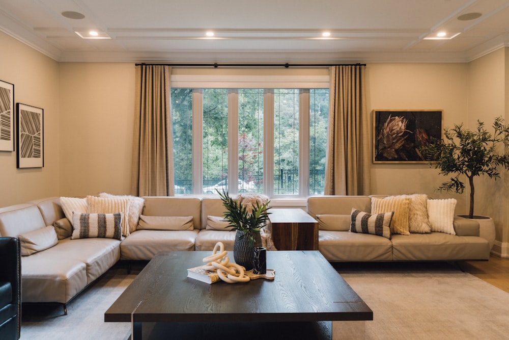 a living room filled with furniture and a large window