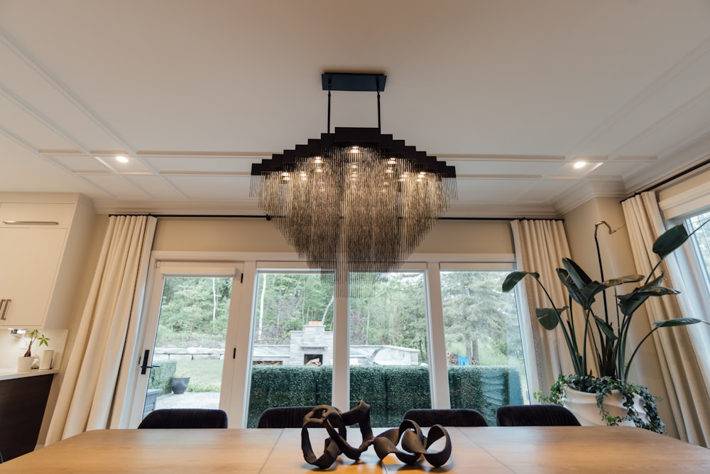 a chandelier hanging from the ceiling in a dining room