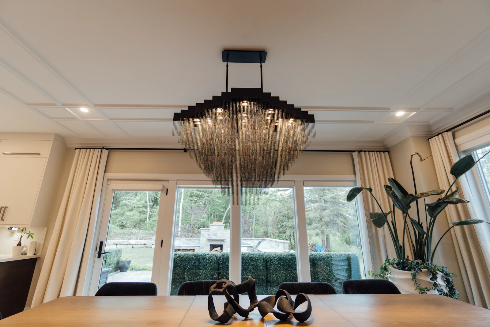 A chandelier hanging above a dining table