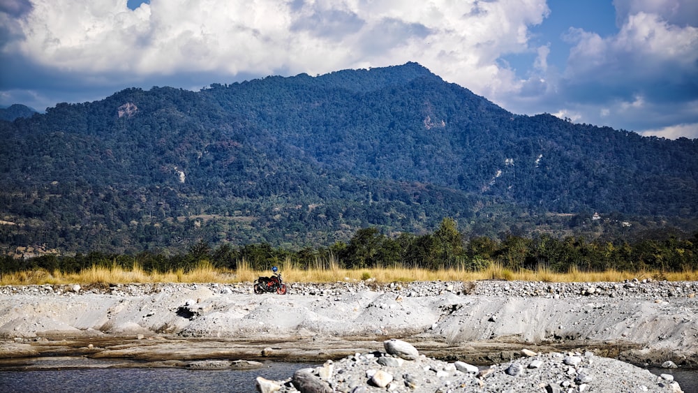 a man riding a motorcycle down a river