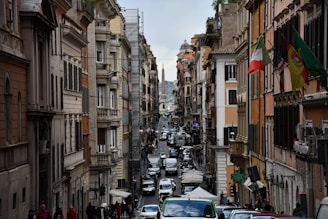 A vibrant street in Italy with students walking and historic buildings in the background.