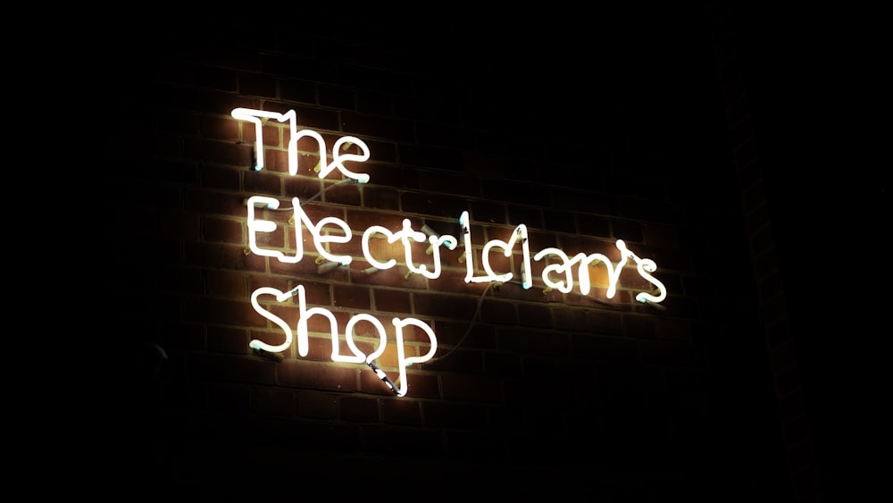 a neon sign that reads the electricians shop