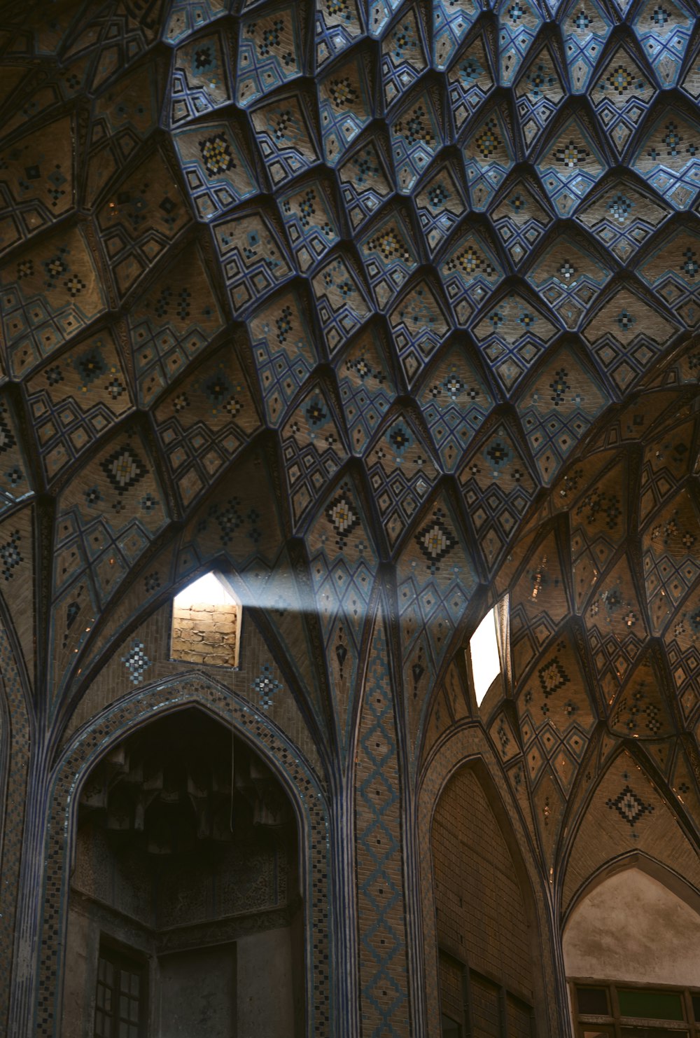 the ceiling of a building with a clock on it