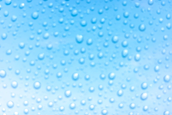 A bright, refreshing splash of aqua water with droplets sparkling against a blue background.