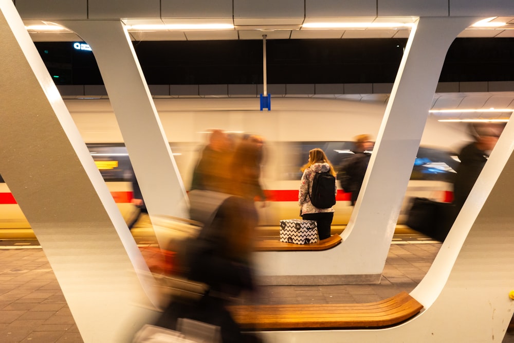 a blurry photo of people waiting at a train station