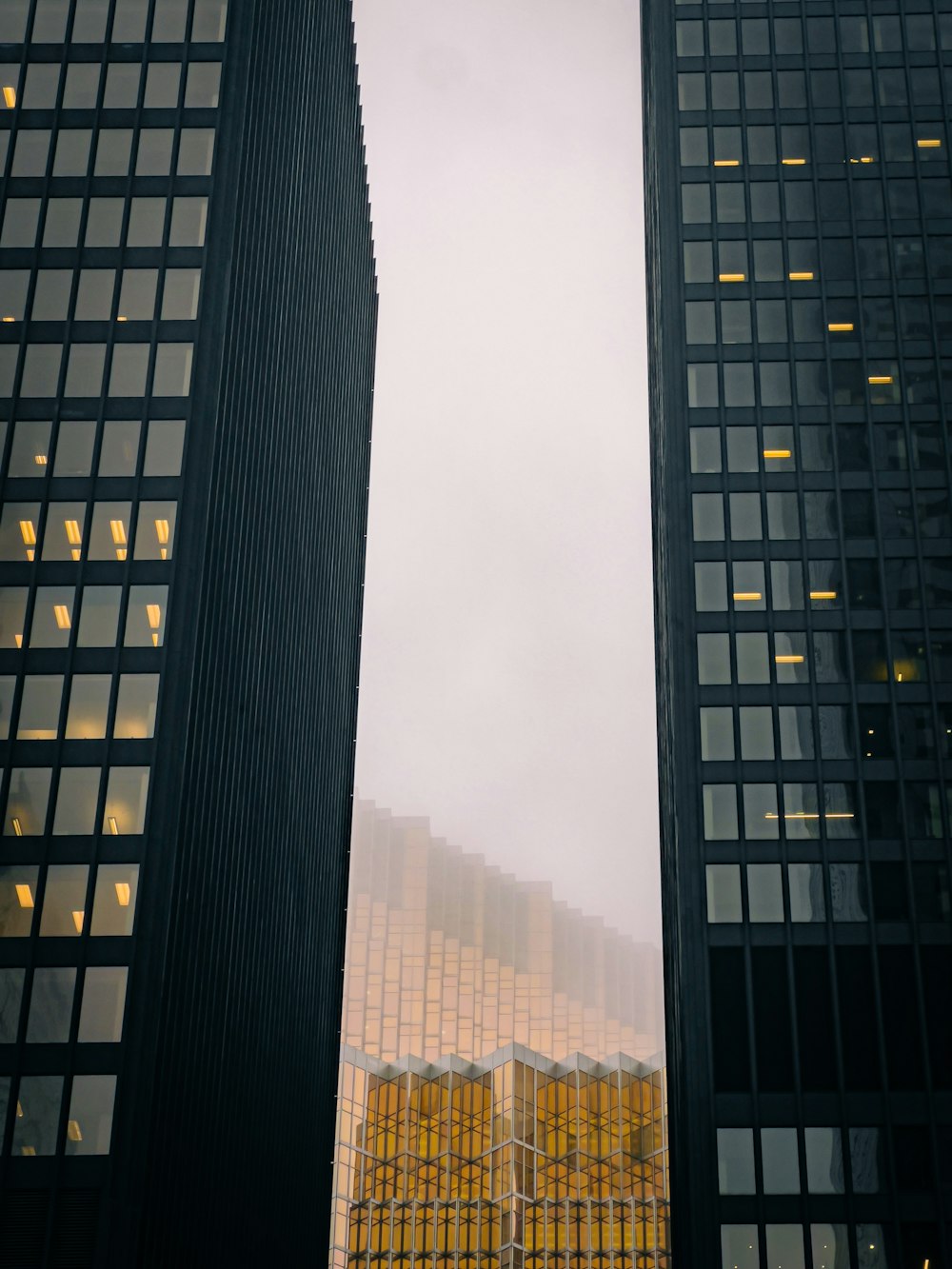 a couple of tall buildings sitting next to each other