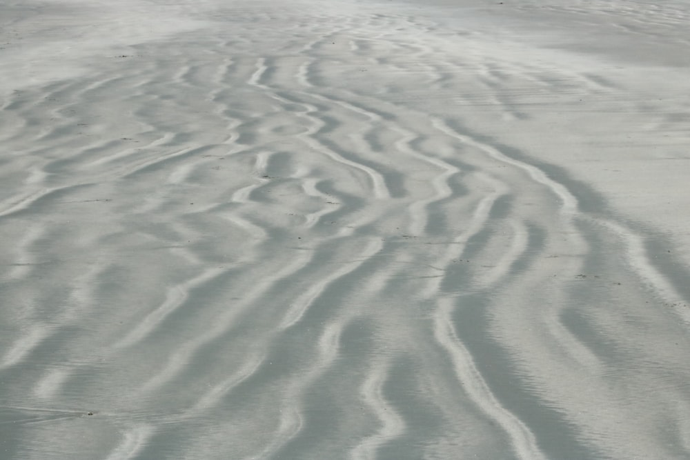 a sandy beach covered in lots of white sand