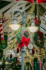 a street light with a christmas wreath on top of it