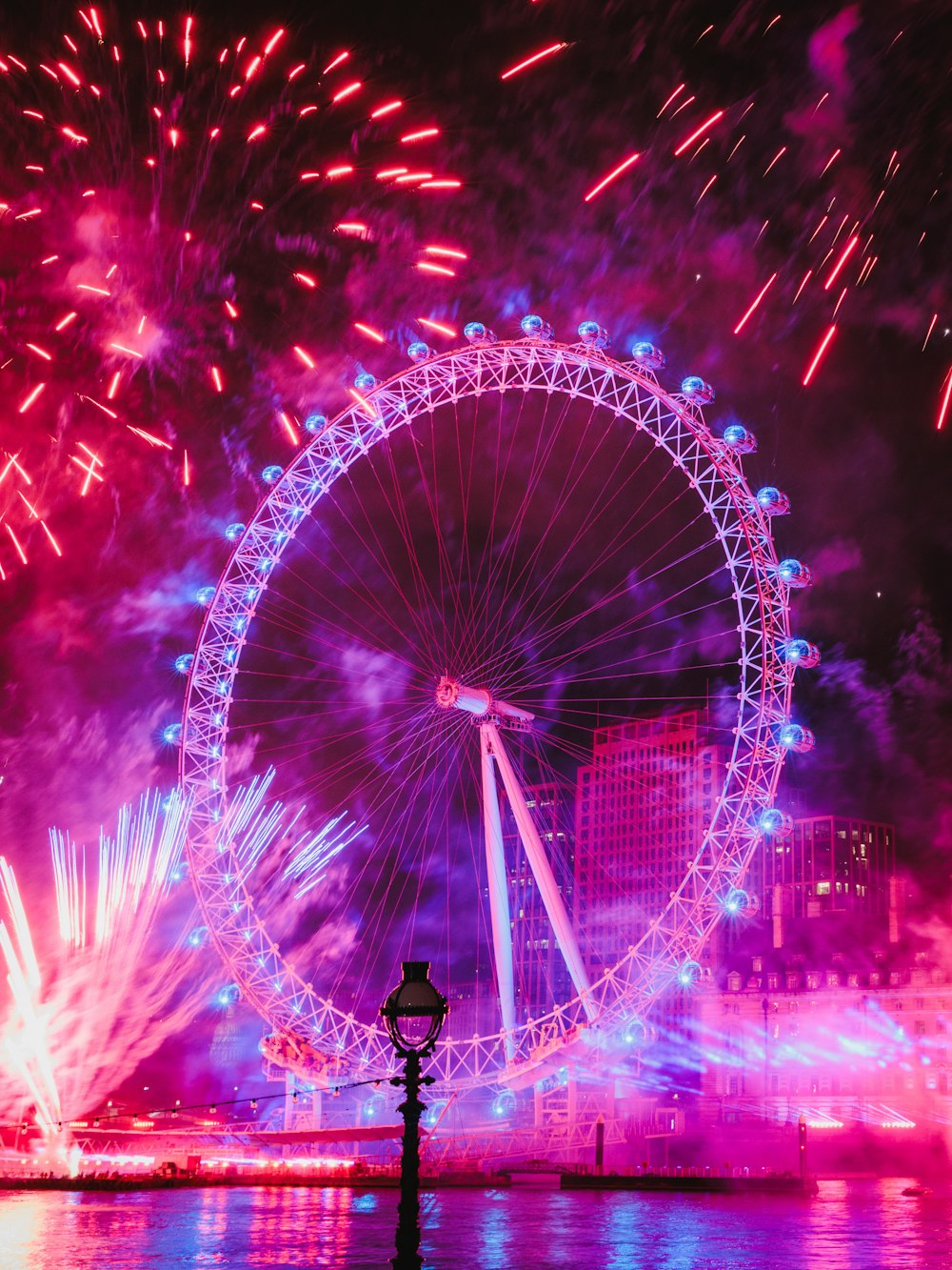 a large ferris wheel lit up in the night sky