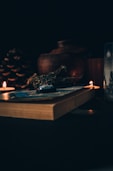 A serene setting with herbs, candles, and ancient books open on love spells.