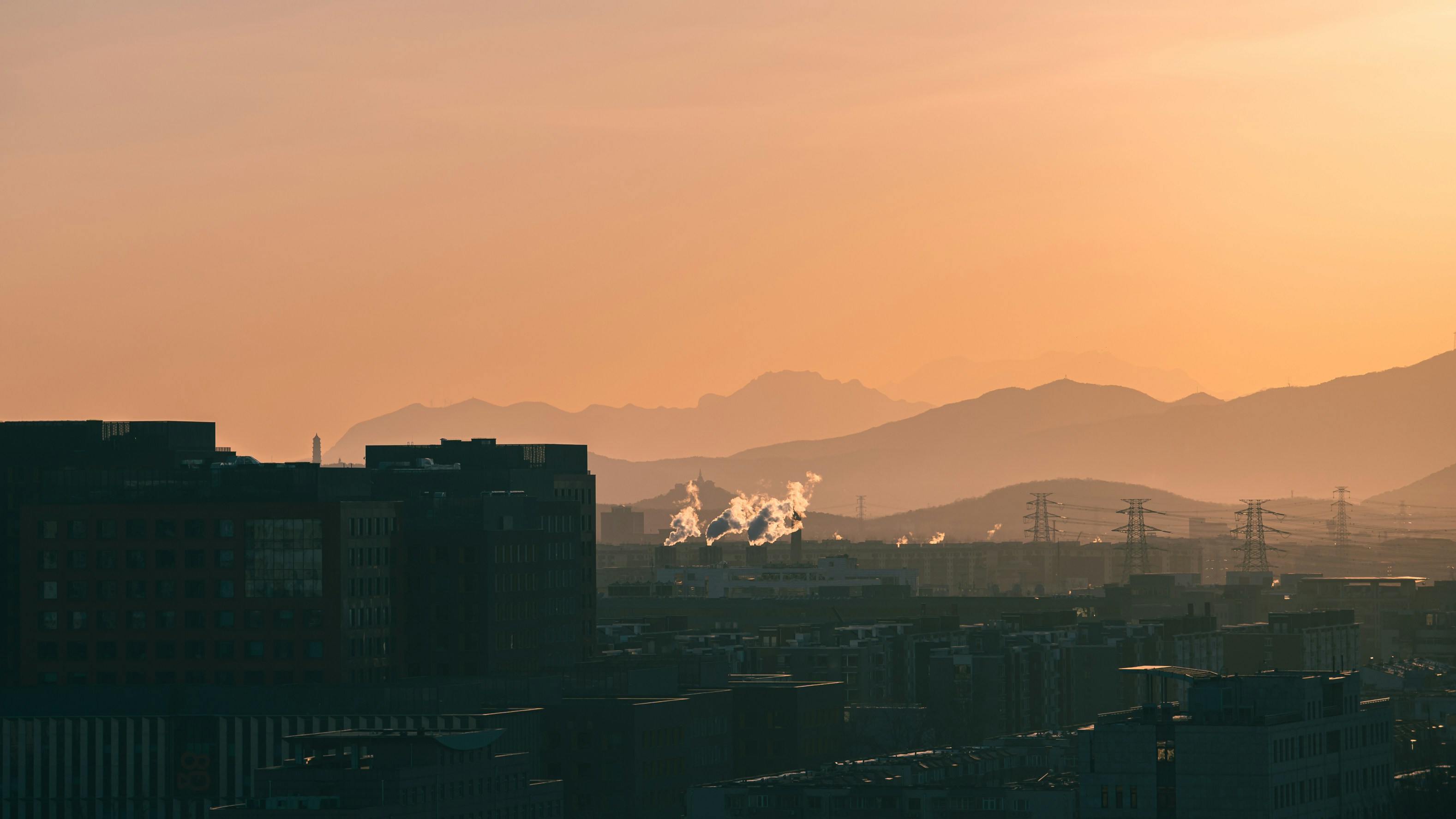 a view of a city with mountains in the background