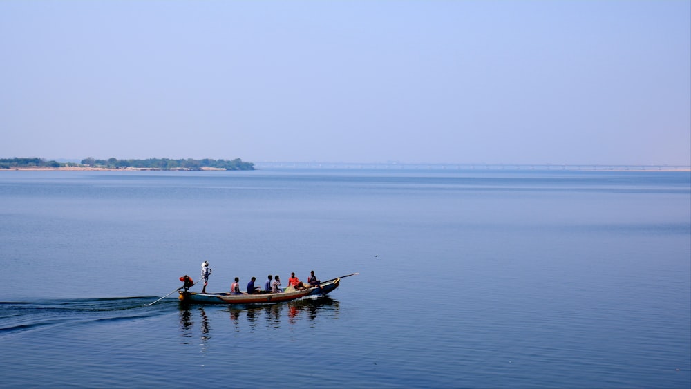 a group of people riding on the back of a boat