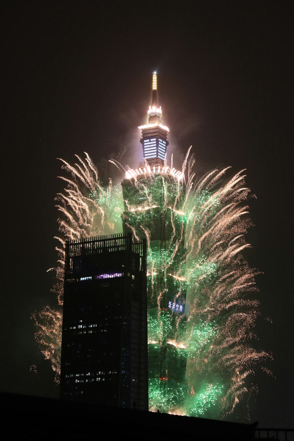 fireworks are lit up in the sky above a city