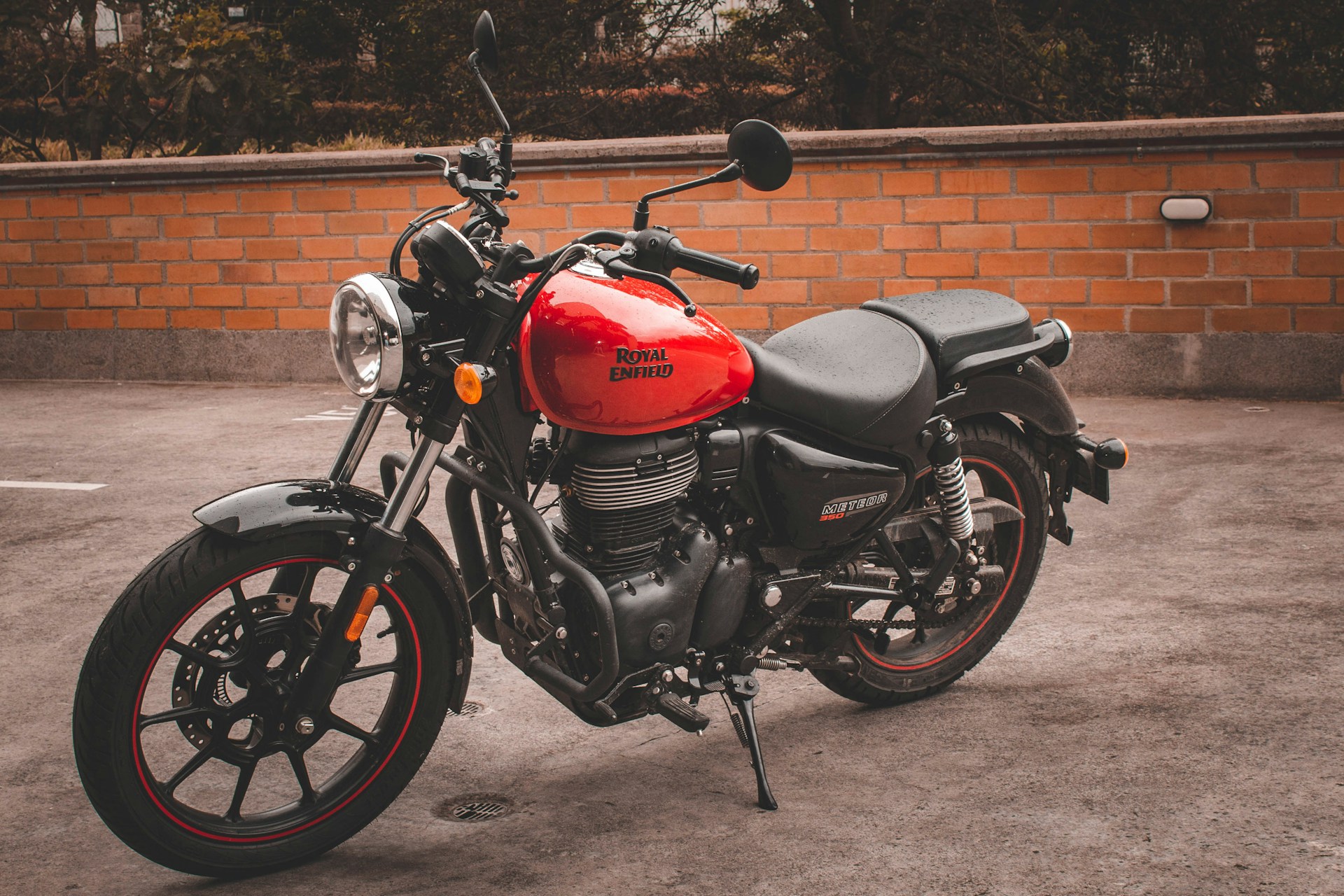 a red and black motorcycle parked in a parking lot